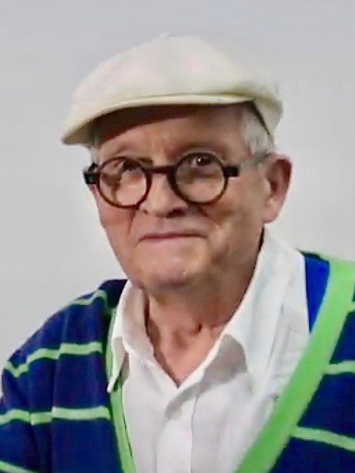 A man wearing glasses and a hat.